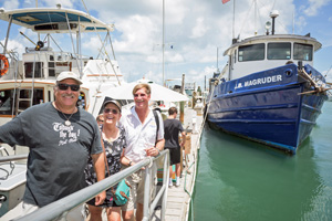 Three members of the Golden Crew welcome the J.B. Magruder at the Schooner Wharf Dock. Image: Nick Doll
